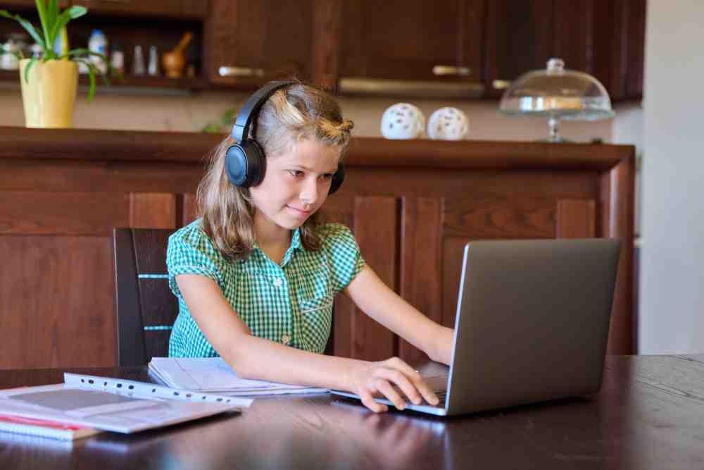 pre teen girl with laptop and headphones studies a 2022 02 10 20 49 16 utc 1