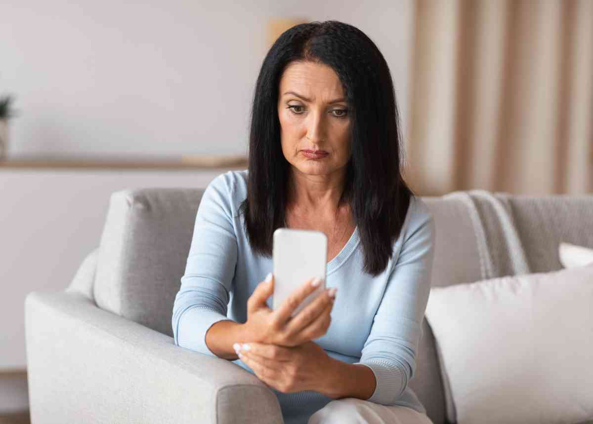 serious mature woman using smartphone at her home 2021 09 02 04 33 07 utc 1