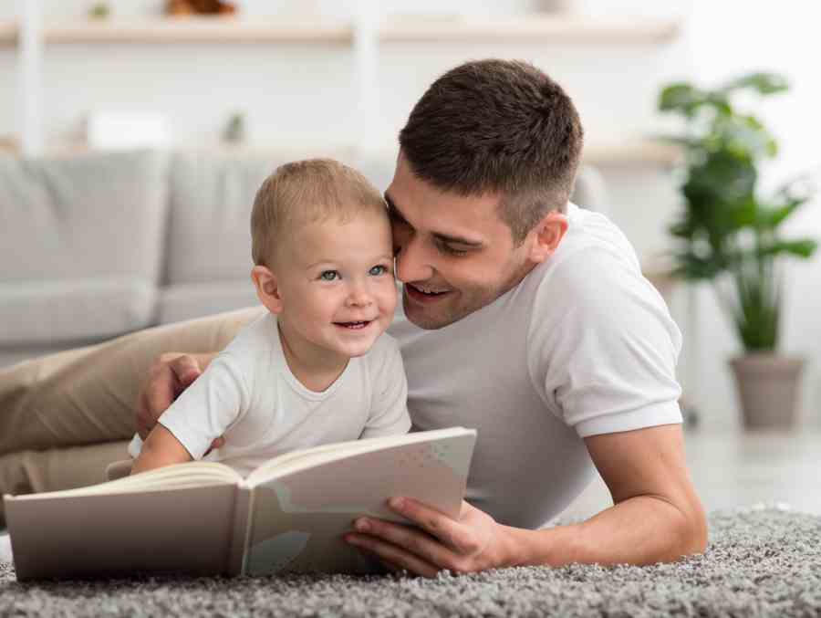 portrait of caring young dad reading book to happy 2022 01 27 23 59 58 utc 1
