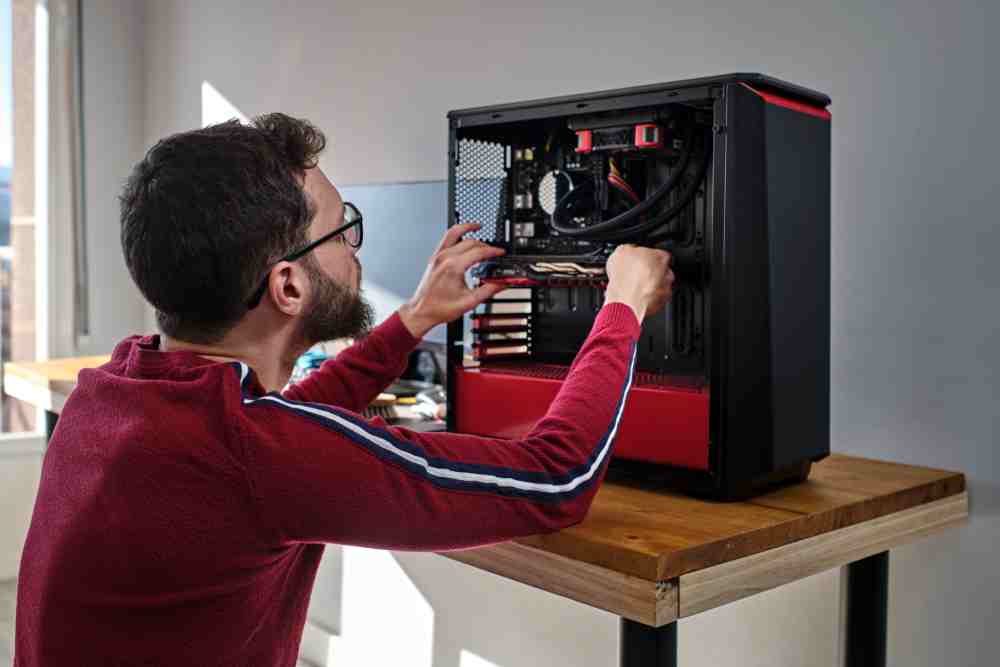 young man installing graphics card to his desktop 2022 03 17 15 56 31 utc 1